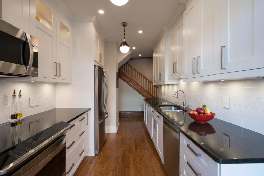 Side-by-side galley-style contemporary kitchen with shaker-style cabinets and crown molding.