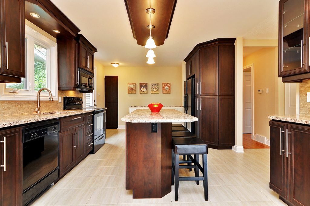A side of view of an open kitchen reno with an island and seating.