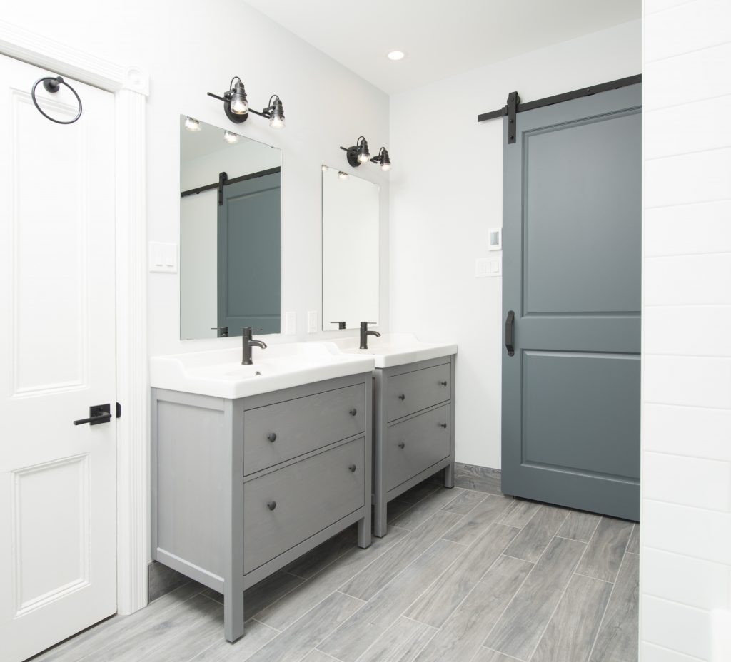 A pair of elegant bathroom vanities and a beautifully elegant sliding door, such as these, are fantastic ideas for bathroom renovations.