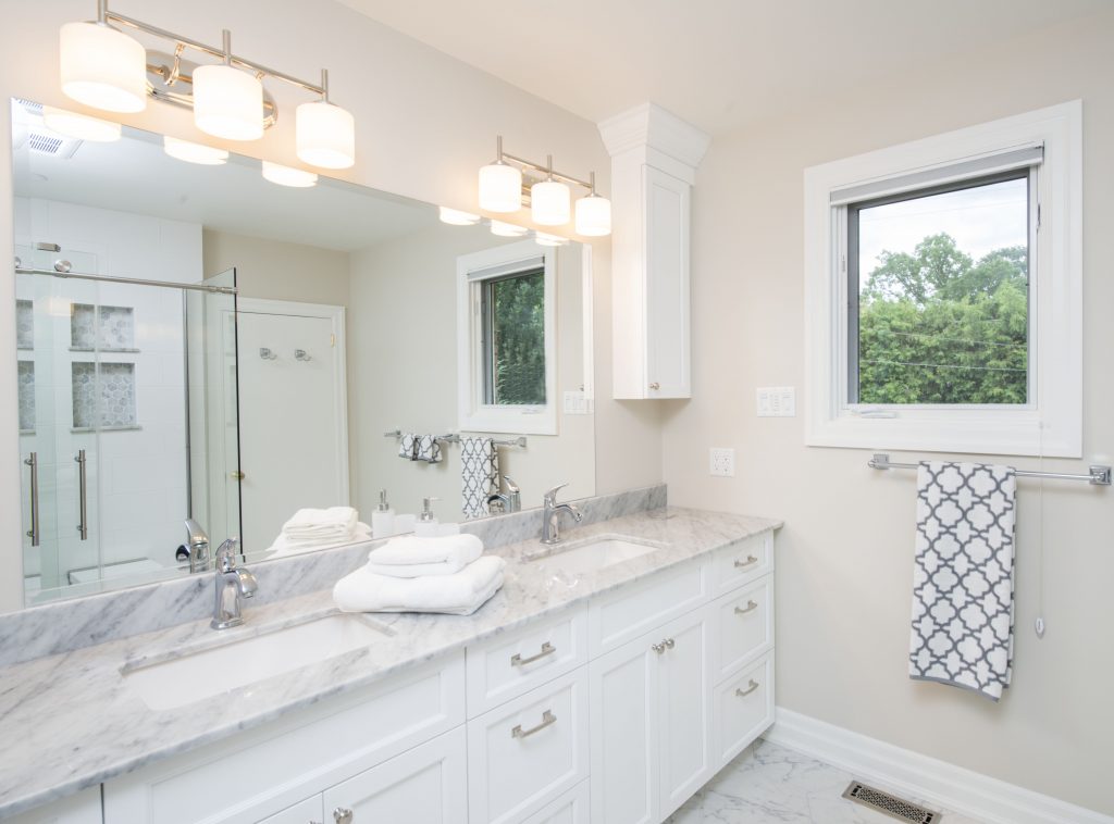 A beautiful marble countertop perfectly complements this renovated bathroom.
