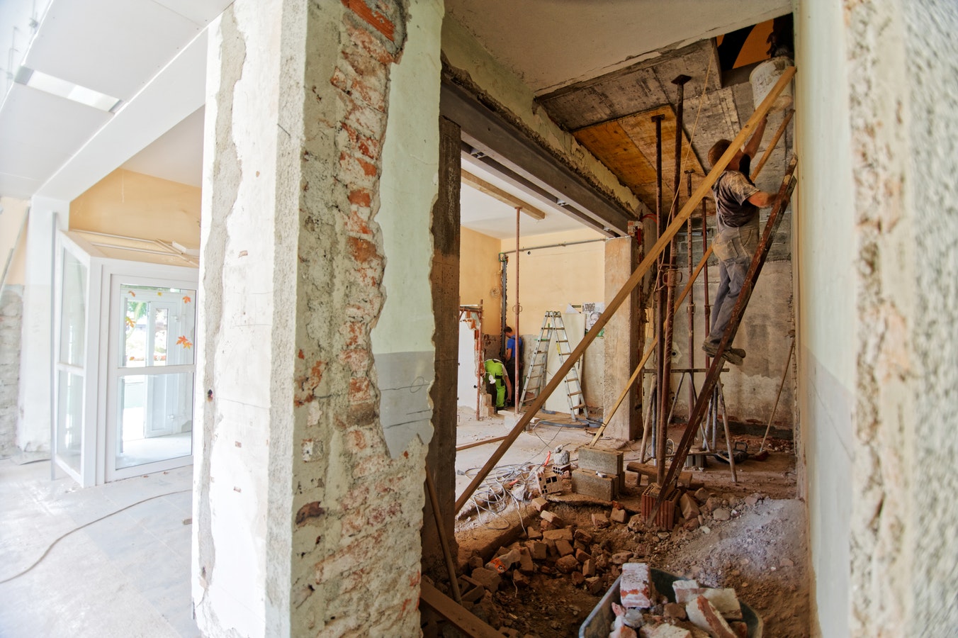 Contractors work on bringing a kitchen design to life as they renovate a fully gutted kitchen.