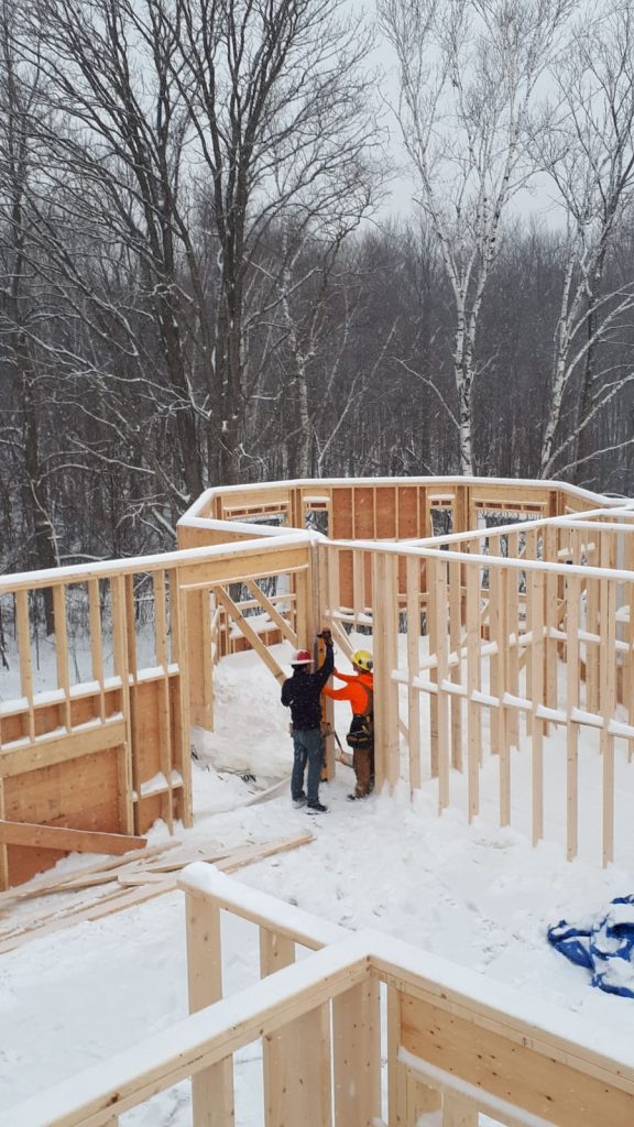 The Sunter Homes team of custom home builders work in fresh snow to finish some framing for a new build.