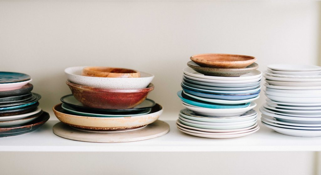 Dishes arranged on an open shelf.