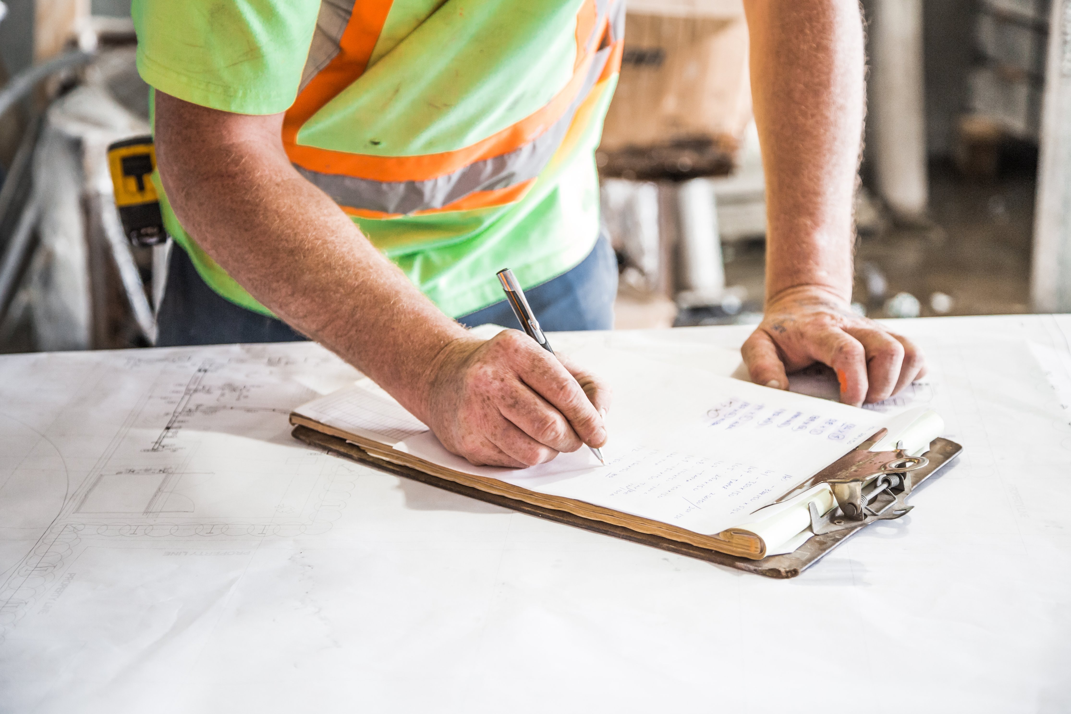 A contractor examining a checklist.