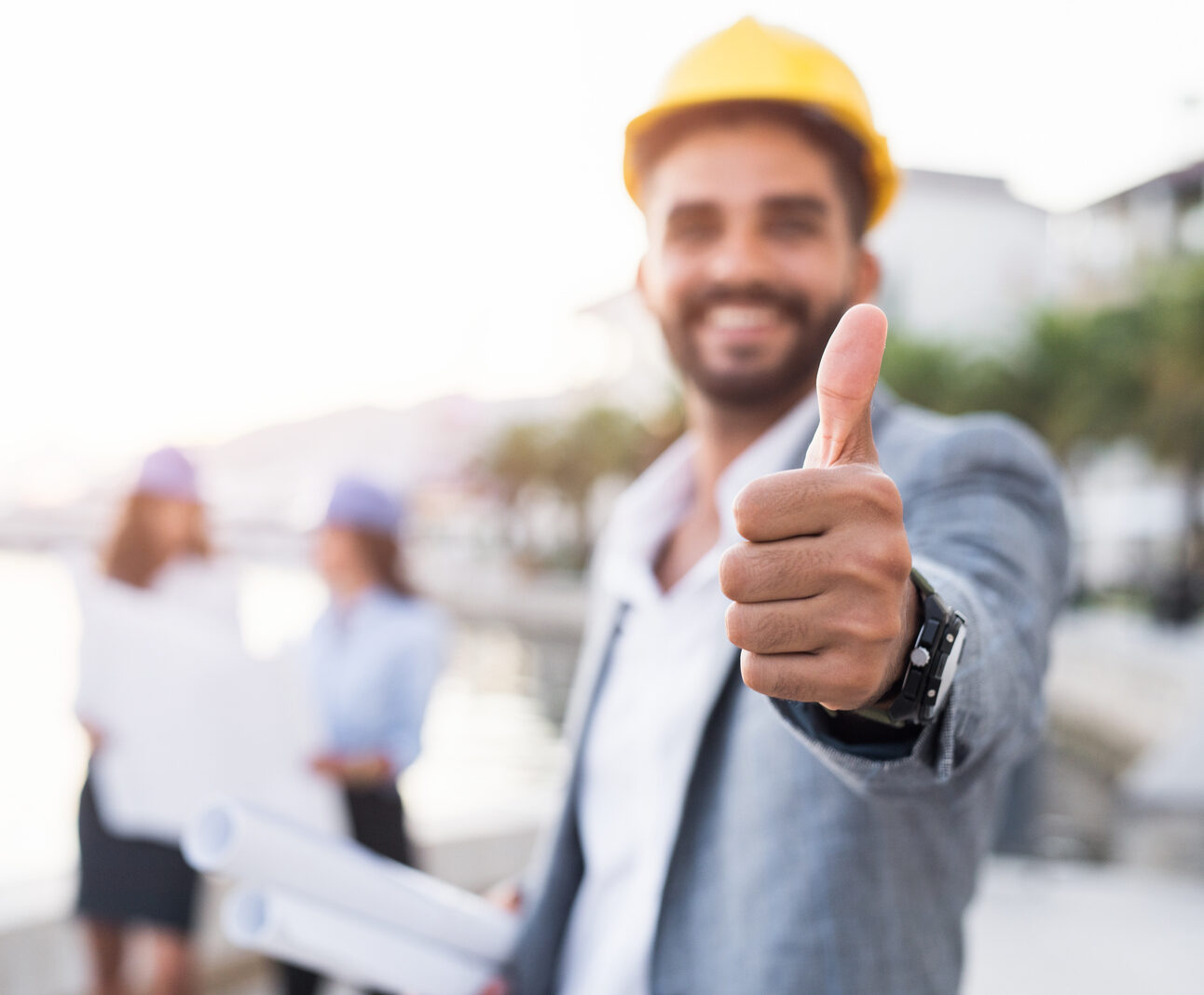 Happy young architect showing thumb up on a harbor.